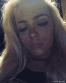 a close up of a woman 's face with the words " thenextbigthing " at the bottom