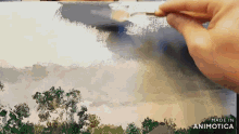 a person is painting a landscape with a brush and the words made in animatica are visible