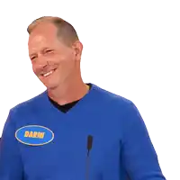 a man wearing a blue sweater has a name tag that says darin on it