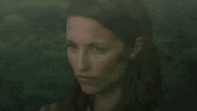 a close up of a woman 's face with red hair