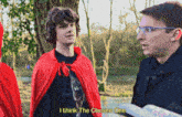 a man in a red cape says " i think the chosen one " next to another man