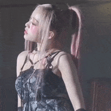 a woman with pink hair is wearing a choker and gloves