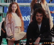a man and a girl are standing next to each other in front of a sign that says on