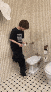 a person standing next to a bidet in a bathroom