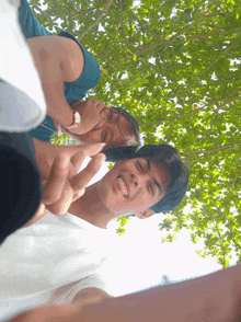 a man giving a peace sign next to another man
