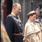 a man and a woman are standing next to each other in a room .