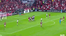 a soccer game is being played on a field with ads for globo play and vivo