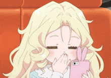 a girl with blonde hair is covering her mouth with her hand while looking at her phone