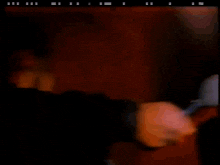 a blurry picture of a man holding a microphone in a dark room