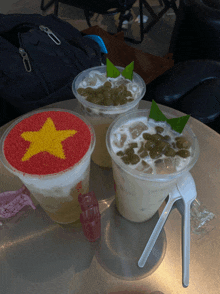 two cups of drinks with a yellow star on top