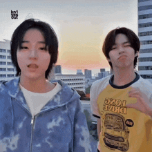 two young men are standing next to each other with one wearing a yellow shirt that says drive tome