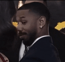 a man in a suit and tie is looking at a woman