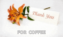 a thank you card is next to a flower
