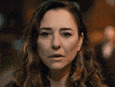 a close up of a woman 's face with a dark background