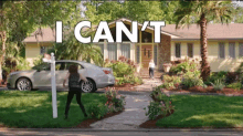 a woman stands in front of a house with the words i can 't written above her