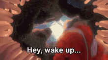 an animated image of a clown fish with the words hey wake up