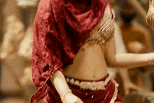 a woman in a red veil is dancing