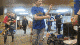 a girl wearing a blue shirt that says ' brooklyn ' on it is dancing
