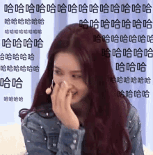 a woman with red hair is covering her nose with her hand and laughing .