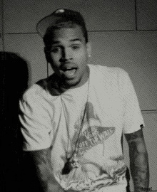 a black and white photo of a man wearing a shirt that says vans on it