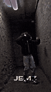 a man standing in a dark hallway with the words and you know jenz