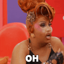 a drag queen says " oh " in a black dress
