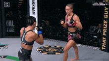 two women are fighting in a boxing ring with a banner that says arkham on it