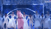 a group of people are dancing on a stage and the words colors are on the bottom right