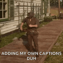 a man in a cowboy hat is standing on a sidewalk with the words adding my own captions duh .