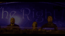 a group of people are standing in front of a sign that says " the right "