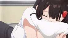 a girl with a flower in her hair is covering her face with a pillow