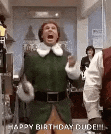 a man in a green elf costume is dancing in a room .