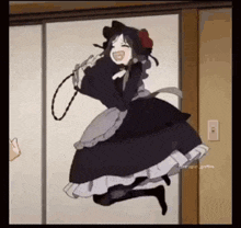 a girl in a maid dress is jumping in the air while holding a rope .