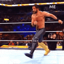 a shirtless wrestler is running in a wrestling ring with the word me written on the bottom .
