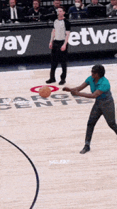 a basketball game is being played on a court with a sign that says ' way ' on it