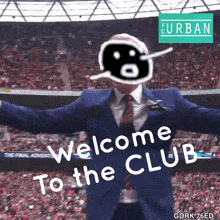 a man in a suit and tie says welcome to the club in front of a crowd
