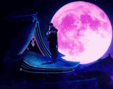 a man is standing on a roof in front of a pink full moon