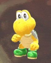 a yellow and green turtle with a backpack on his back is standing on a brown surface .