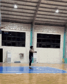 a basketball player is jumping in the air to catch a ball