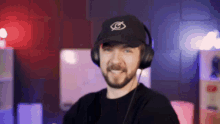 a man with a beard wearing headphones and a hat