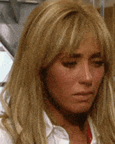 a close up of a woman 's face with a tear running down her cheek .