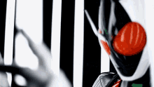 a black and white striped background with a red ball in the middle