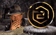 a man in a hat is covering his mouth in front of a coin that has the letter e on it