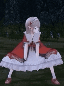 a girl in a red cape and white dress is squatting down in a forest .