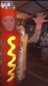 a woman is dressed as a hot dog with mustard on it