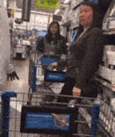 a woman pushing a shopping cart in a store with a sign that says attention shoppers