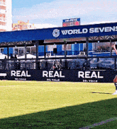 a soccer field with a sign that says world sevens