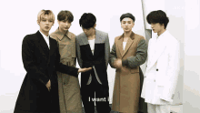 a group of young men standing next to each other with the words " i want it " on the bottom right