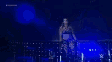 a girl is standing on a stage with the word all over the screen