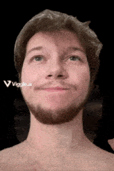 a man with a beard and a plastic bag on his head looks up at the camera with a viggle.ai logo behind him
